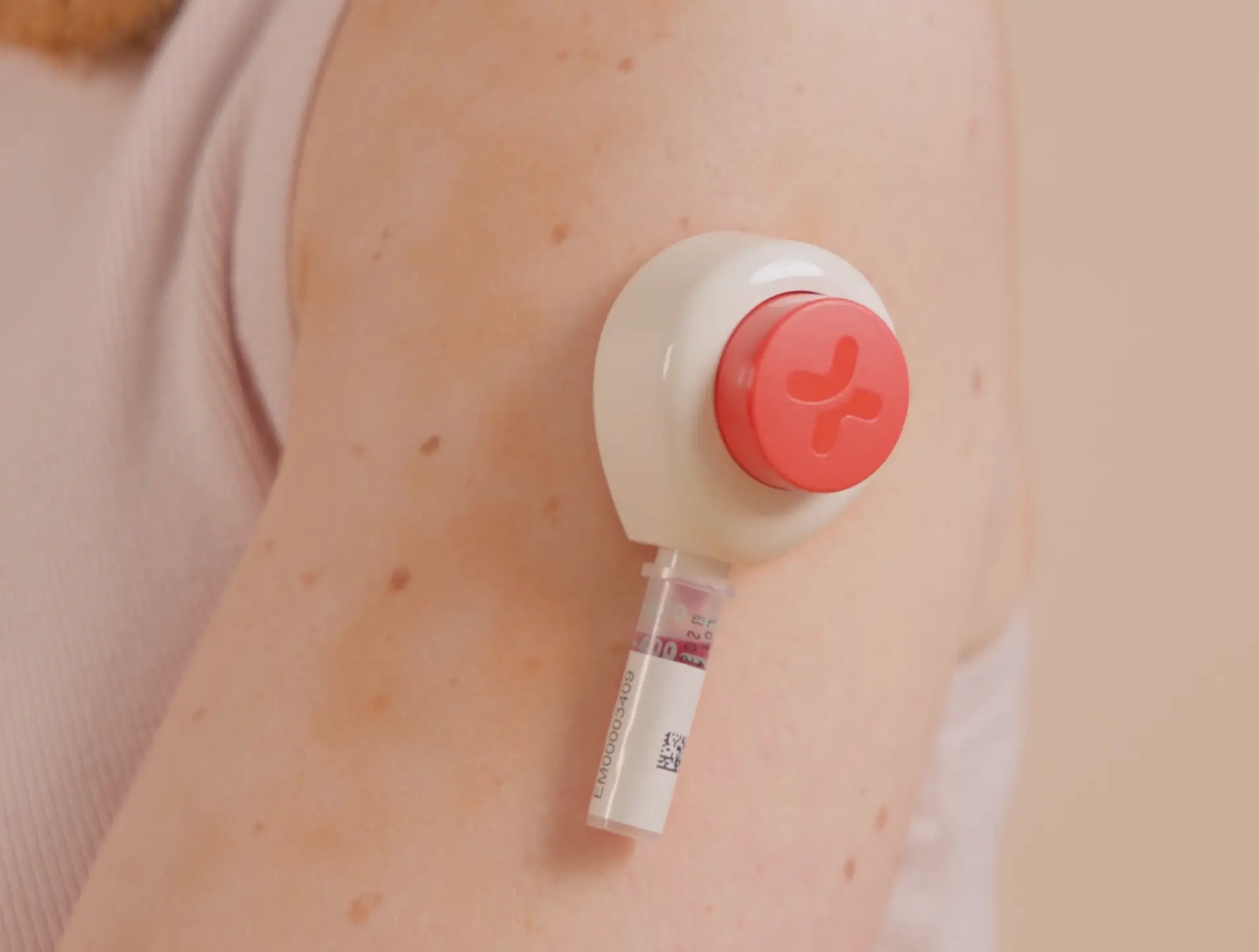 Close-up of a blood collection device attached to a person's upper arm.