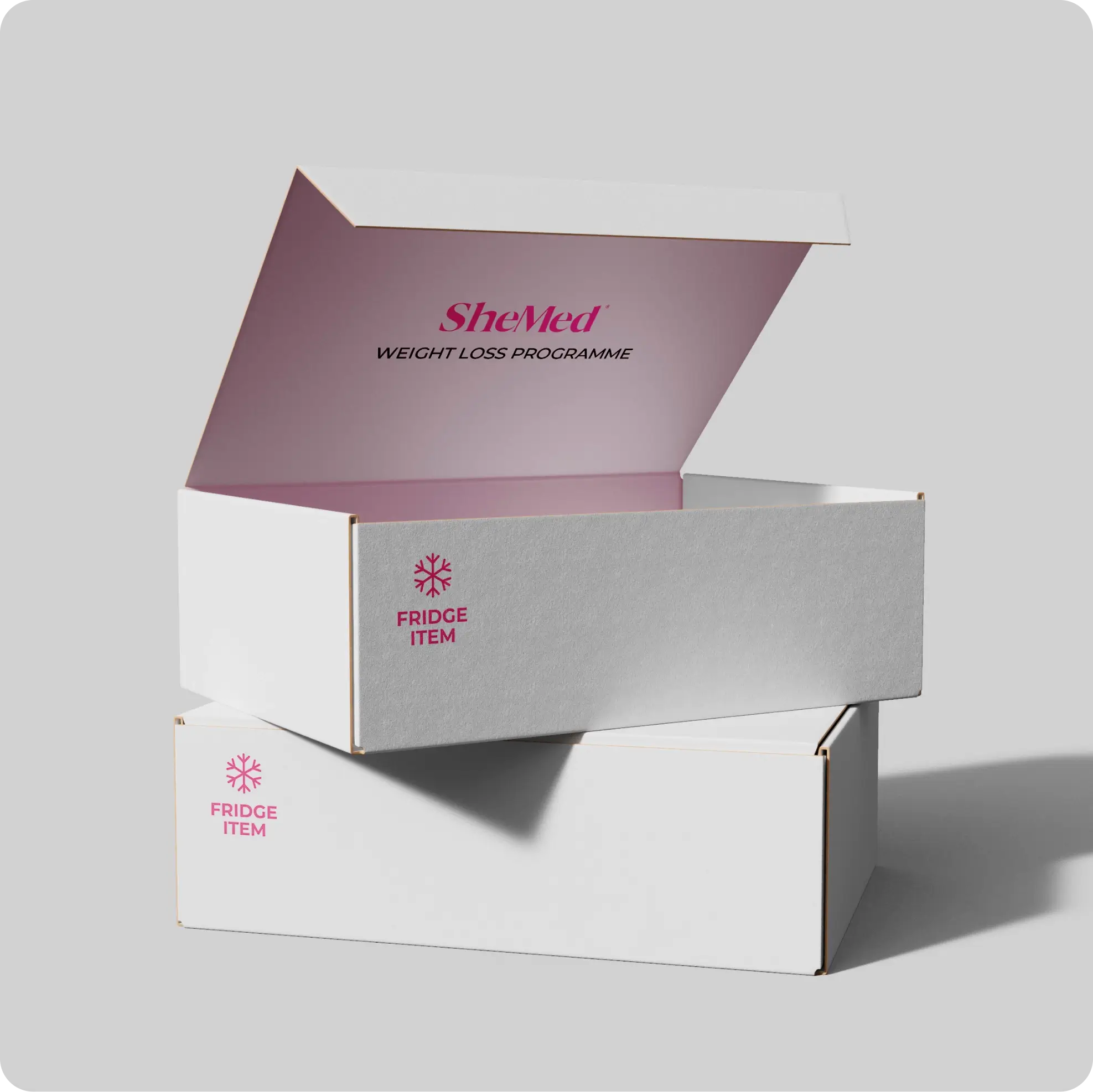 Two white cardboard boxes stacked, the top one open showing the text SheMed Weight Loss Programme inside the lid and a fridge item symbol on the side.