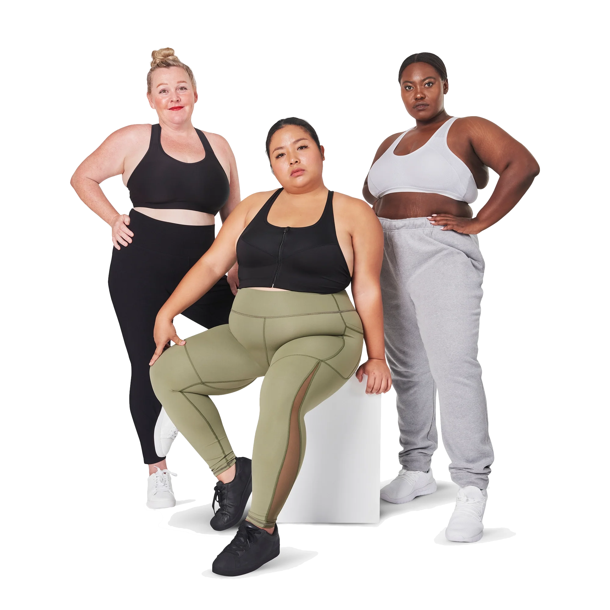 Three diverse plus-size women in athletic wear posing confidently, one seated and two standing.