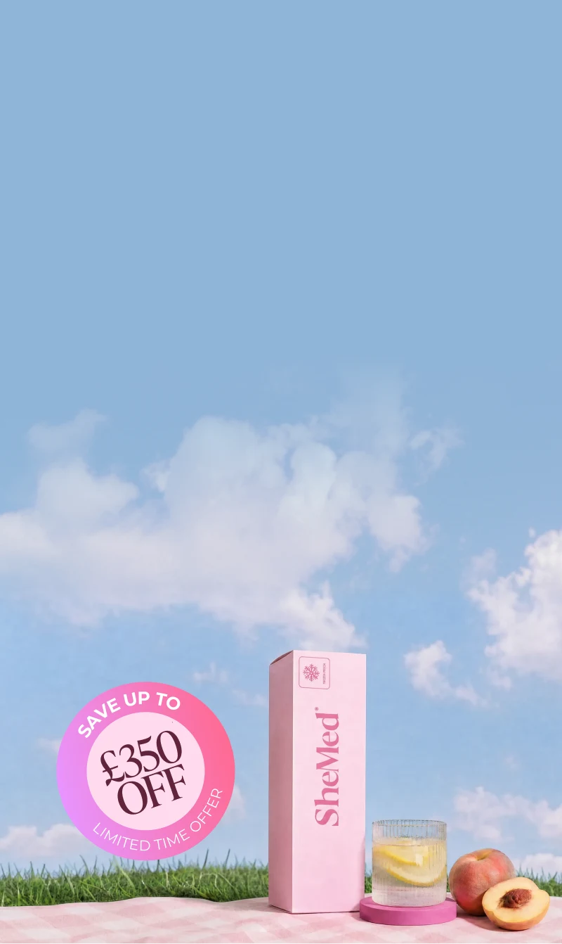 A pink SheMed weight loss programme box alongside a glass of lemon water and fresh peaches on grass under a blue sky, featuring a £350 off sale badge on the SheMed clinician-led weight loss programme for UK women.