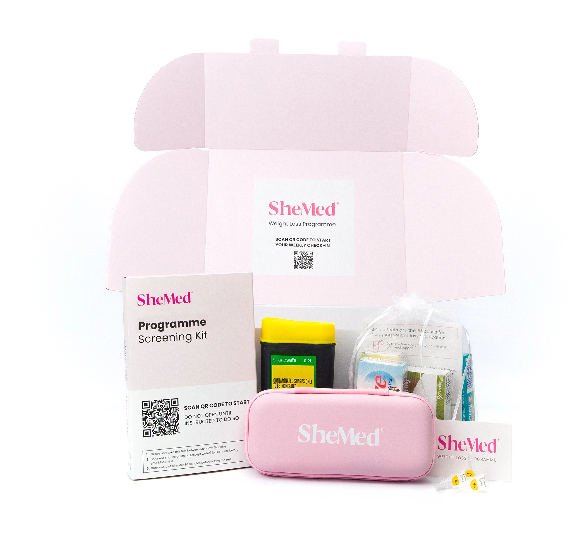 An open SheMed weight loss starter kit box containing a blood screening kit, container, pink side-effect care case, and supplements, showing everything included in the SheMed clinician-led weight loss programme for UK women