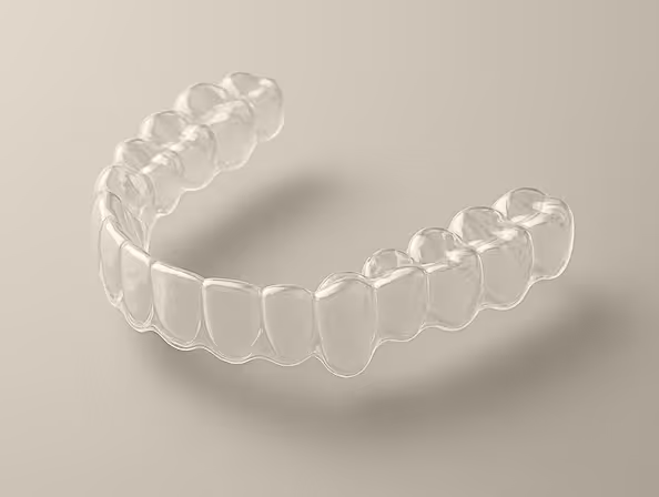 Transparent clear dental aligner for orthodontic teeth straightening on beige background.