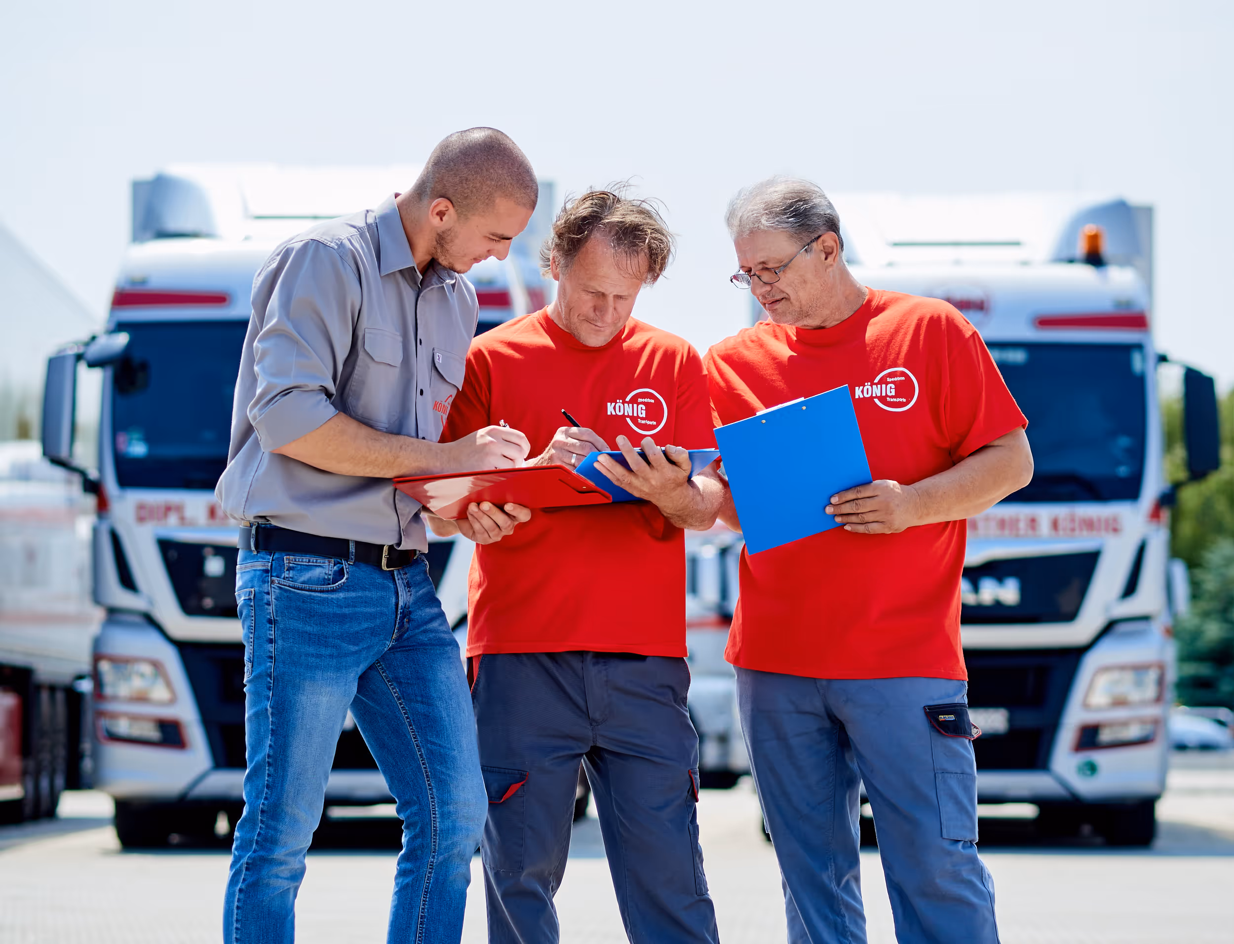 Drei Personen beugen sich über ein Formular