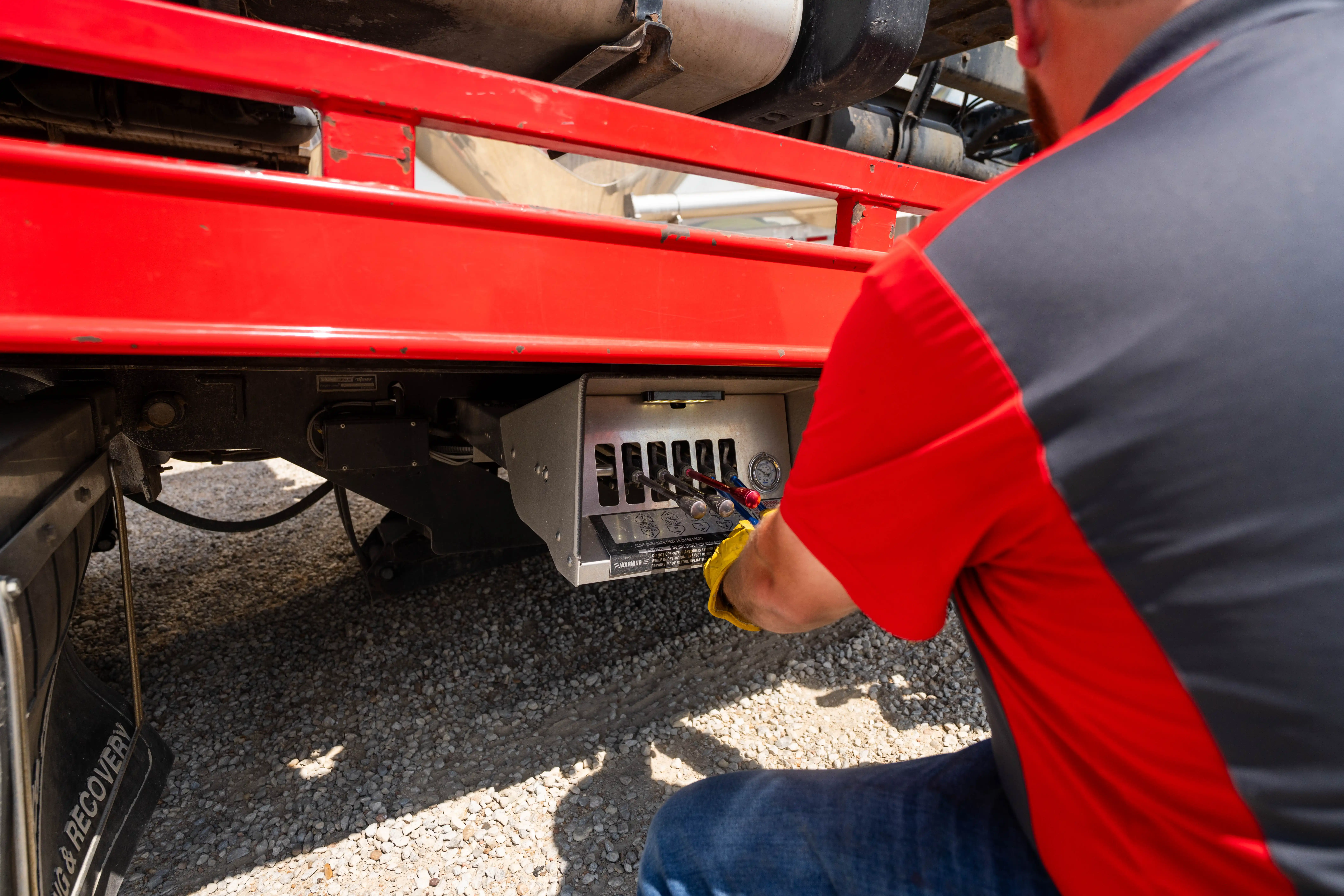 Auto House technician working the hydraulic controls on a rollback deck