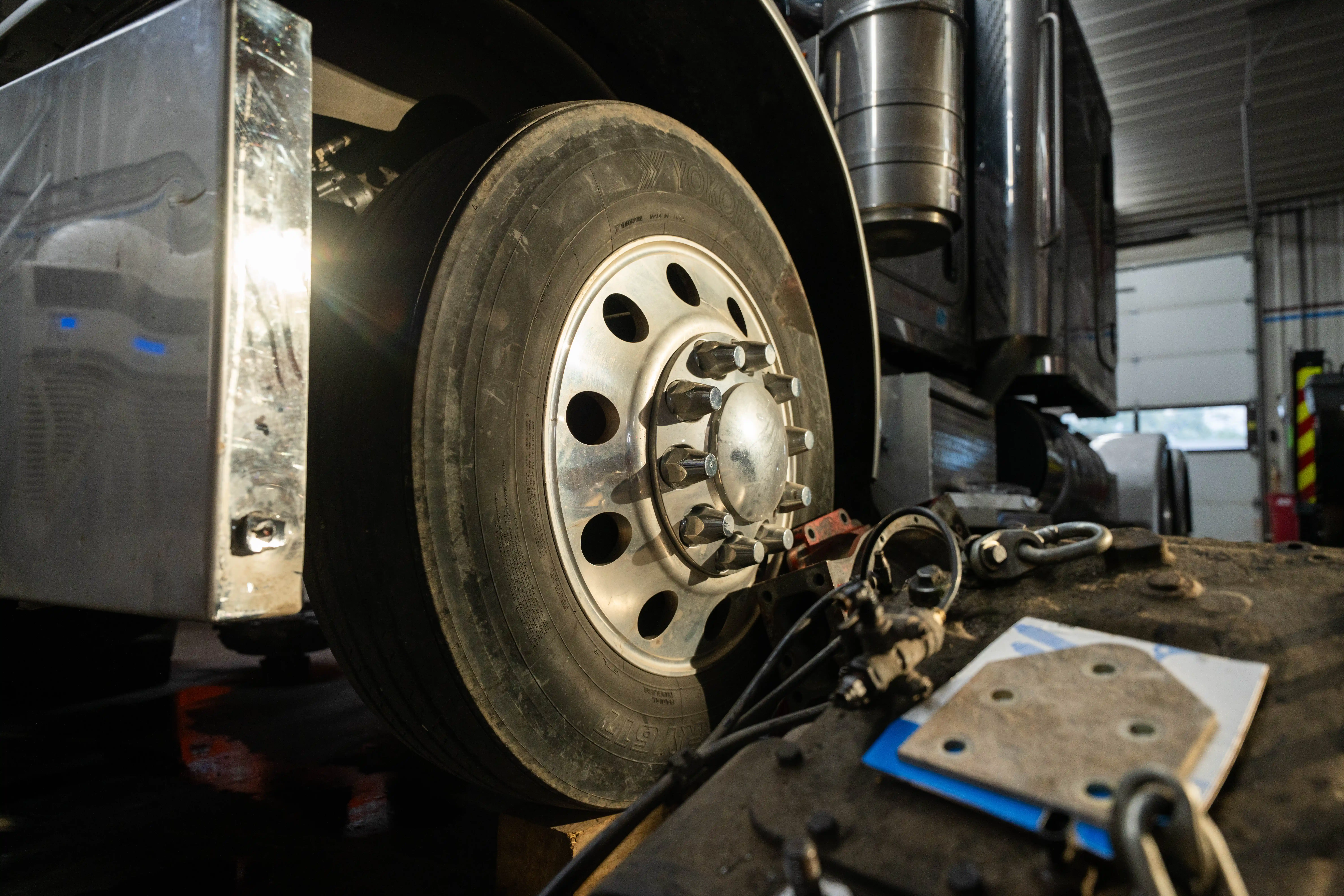 Truck steer wheel and tire being serviced in the Auto House shop
