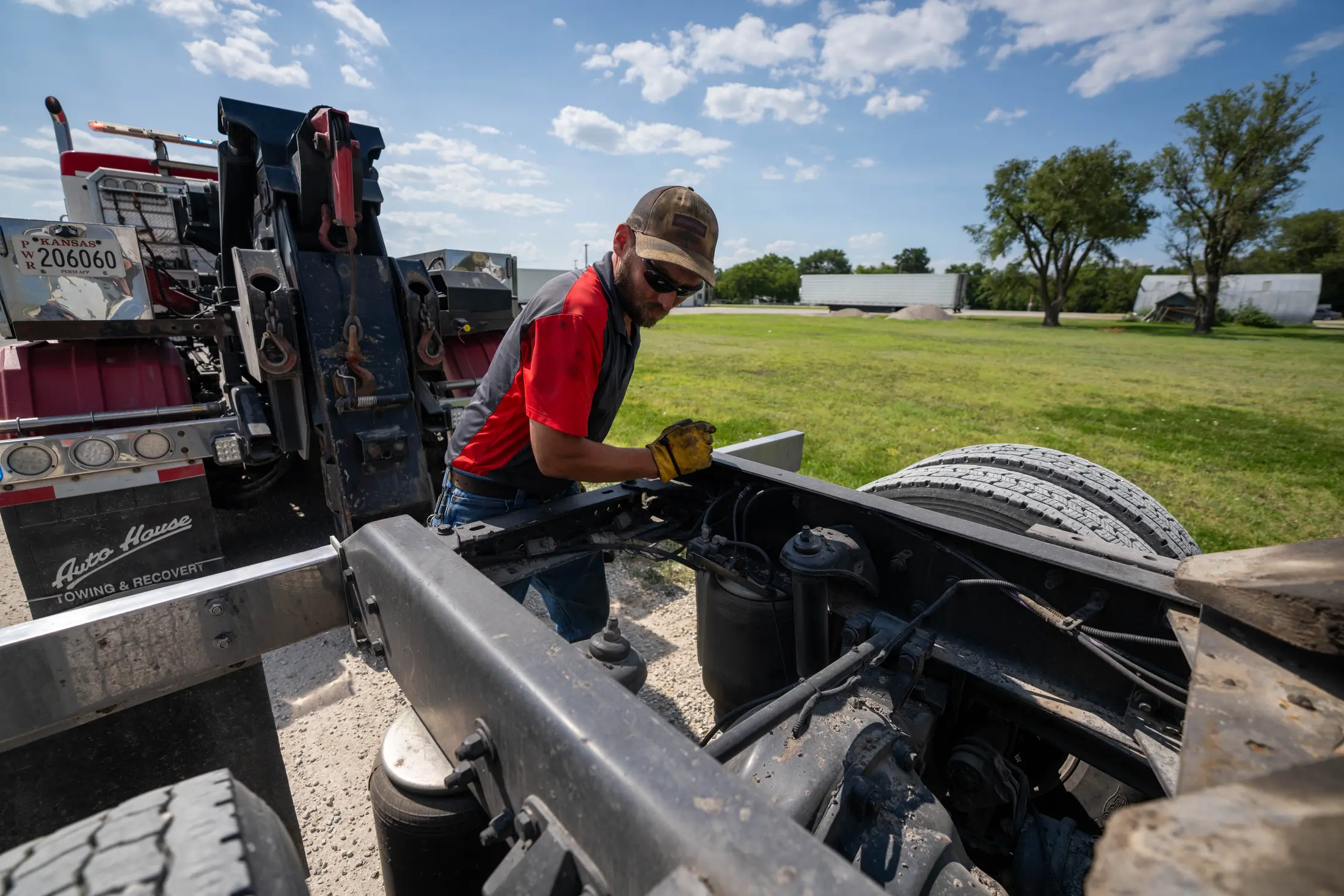 Technician connecting a semi tractor to an Auto House wrecker underlift