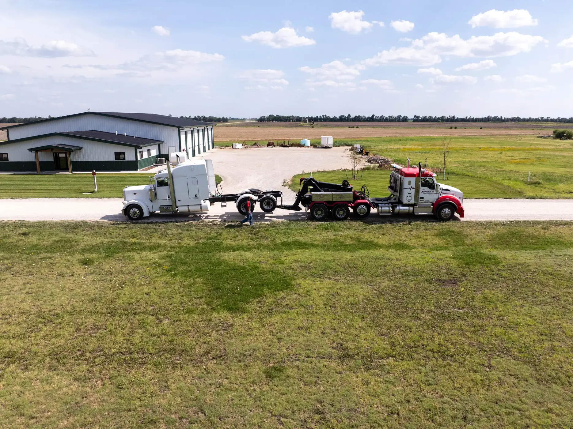 Aerial view of an Auto House wrecker towing a Peterbilt sleeper