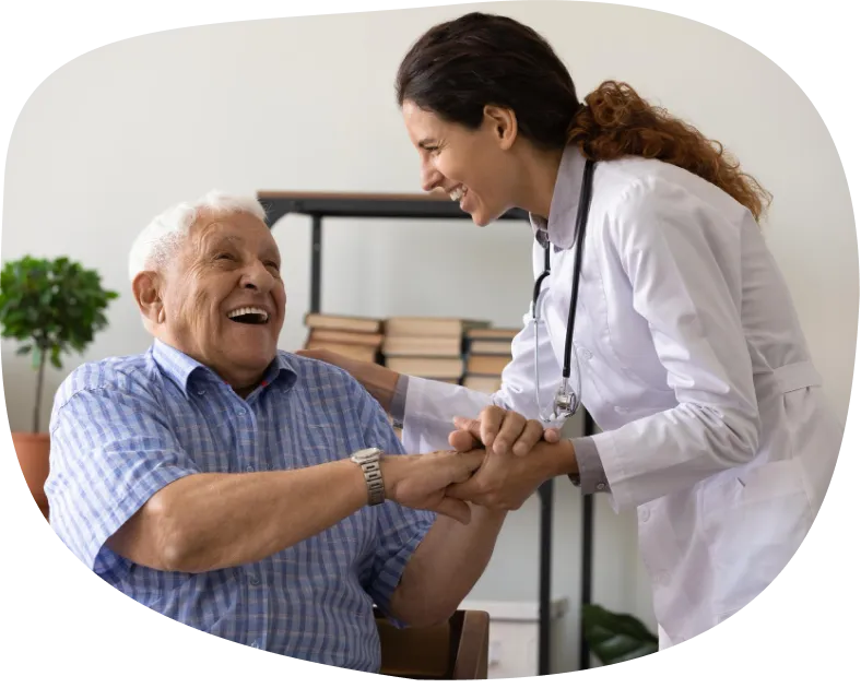 Healthcare professional greeting an older man at home