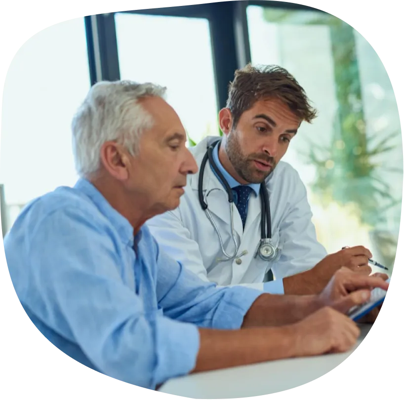 Healthcare professional reviewing information with an older man