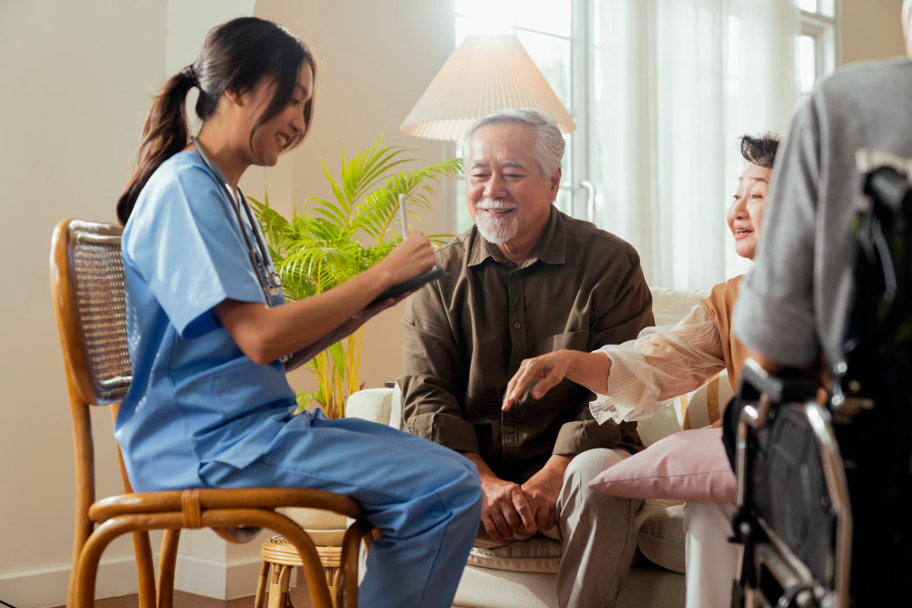 Healthcare professional talking with an older couple at home