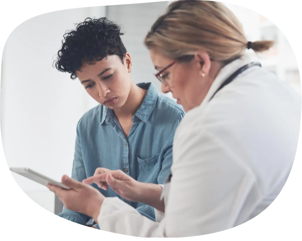 Healthcare professional reviewing a tablet with a patient
