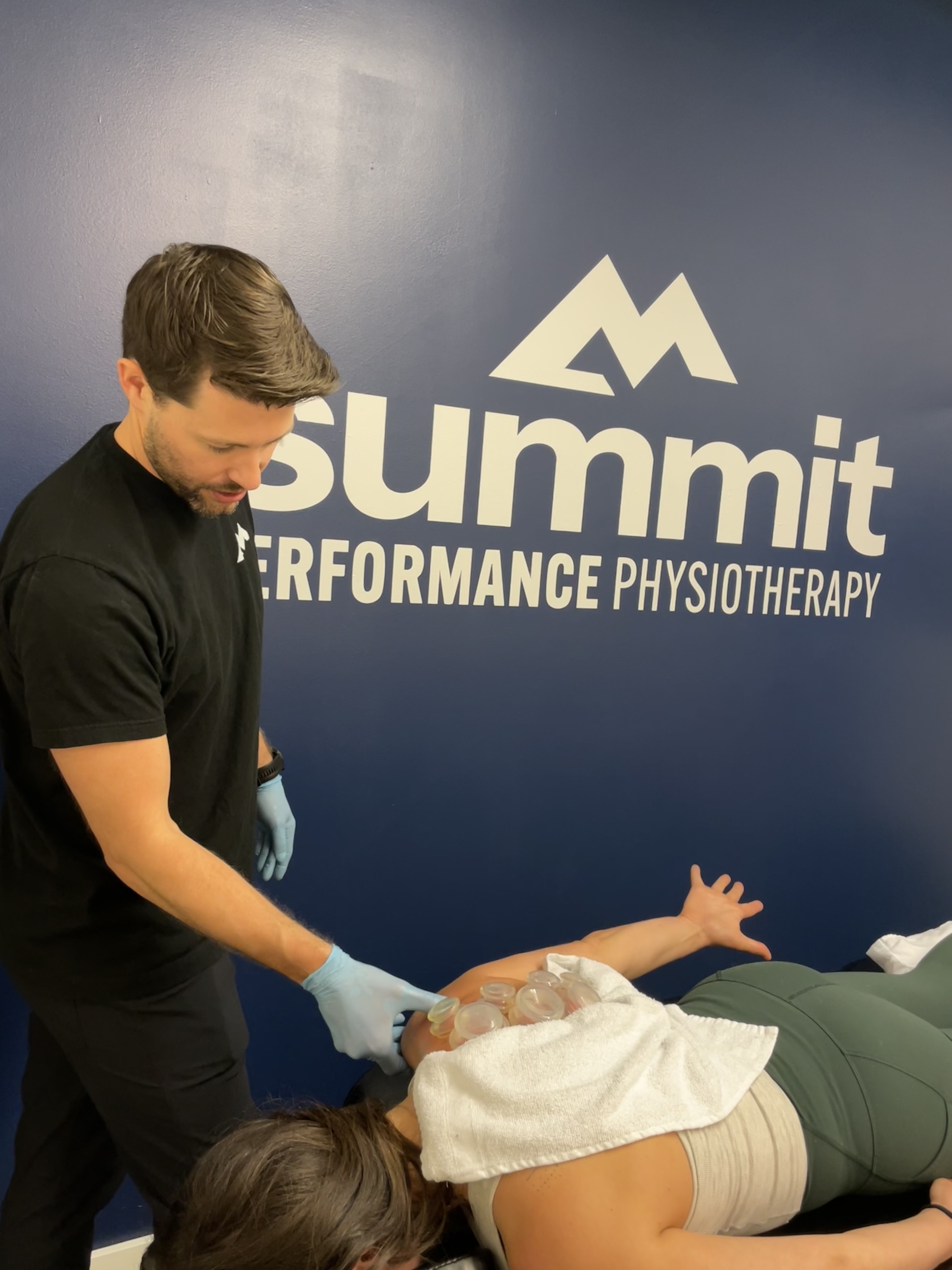 : Patient receiving one-on-one manual therapy for shoulder pain at a sports physical therapy clinic in Denver, CO