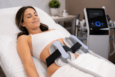 Woman receiving Emsculpt Neo treatment for stubborn belly fat at a medical spa in Austin, Texas