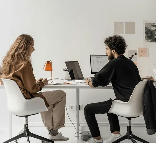 Launchist team members meeting and working together at a desk 