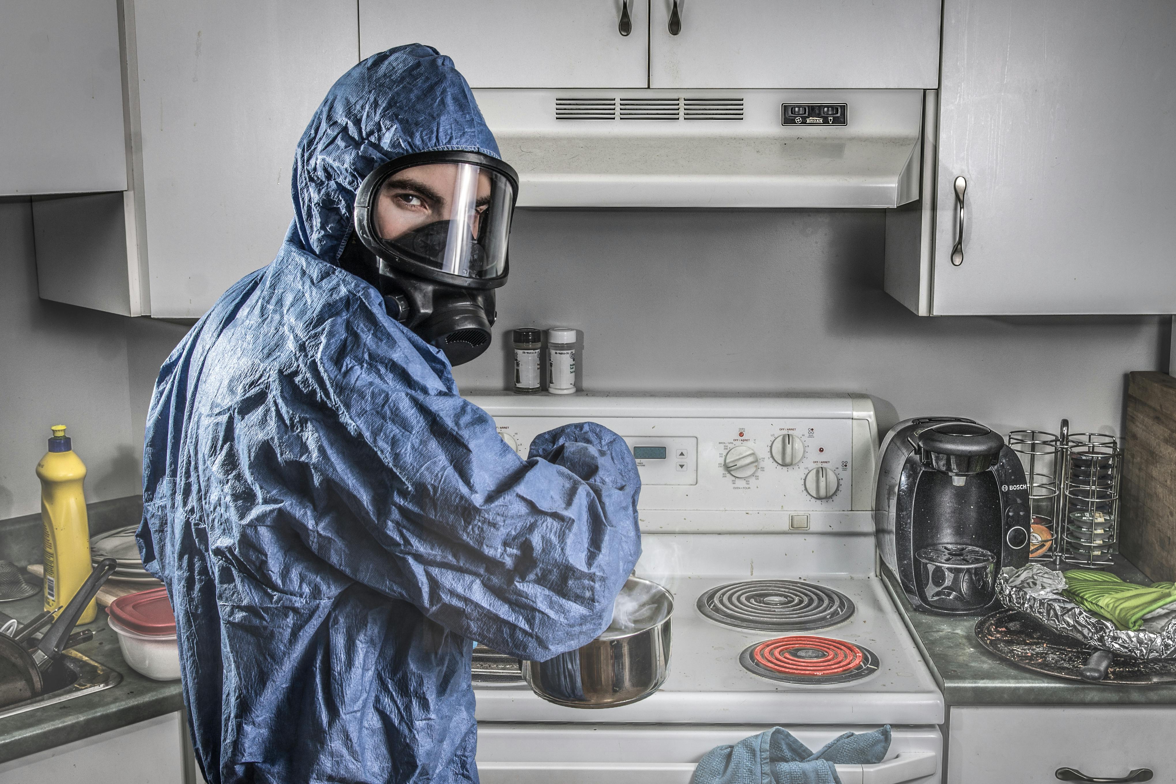 A chef's hands wearing bright blue food safety gloves cutting meat on a black chopping board, emphasizing operational compliance and strict workplace safety standards.