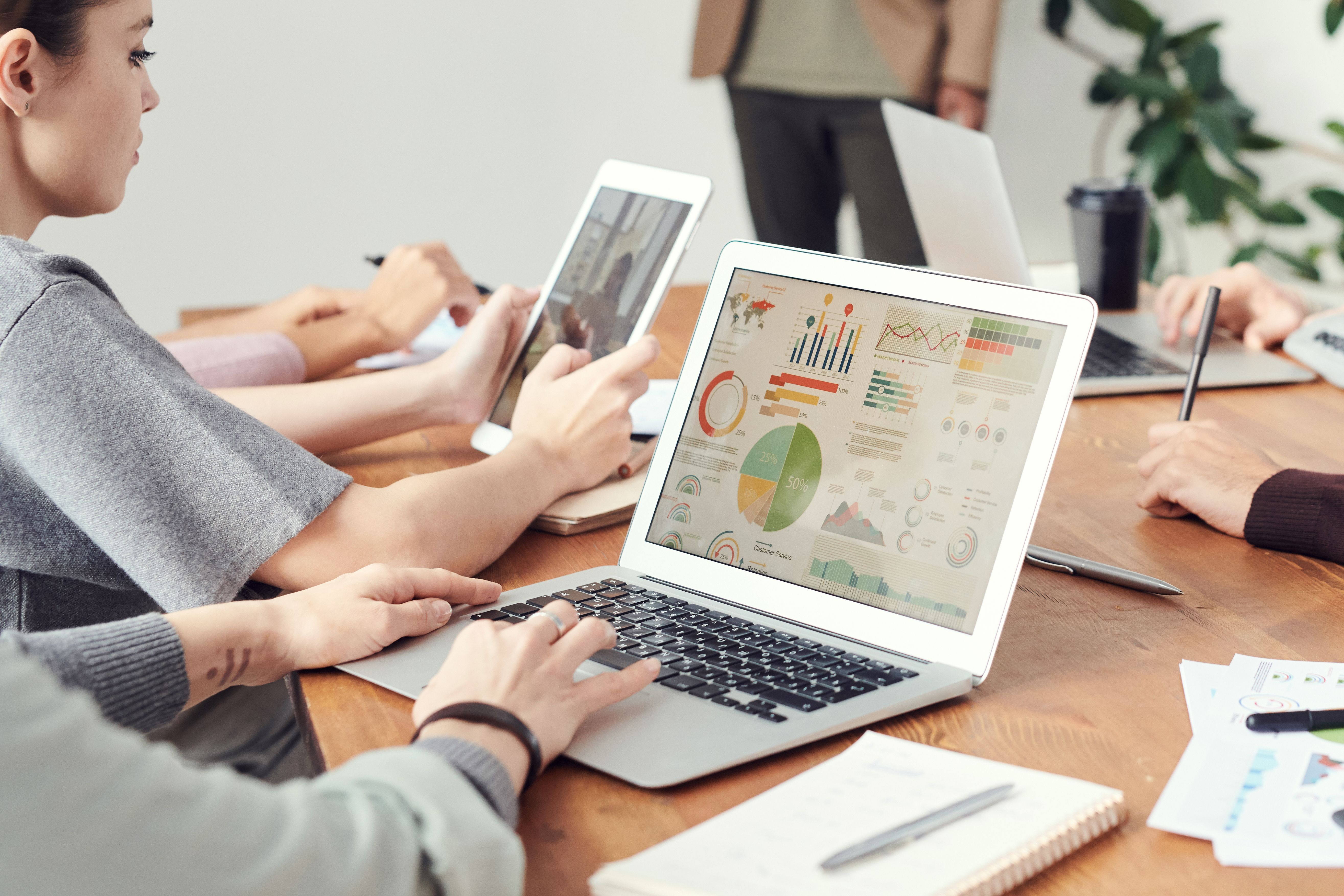 eam member analyzing data analytics and reports on a modern laptop.