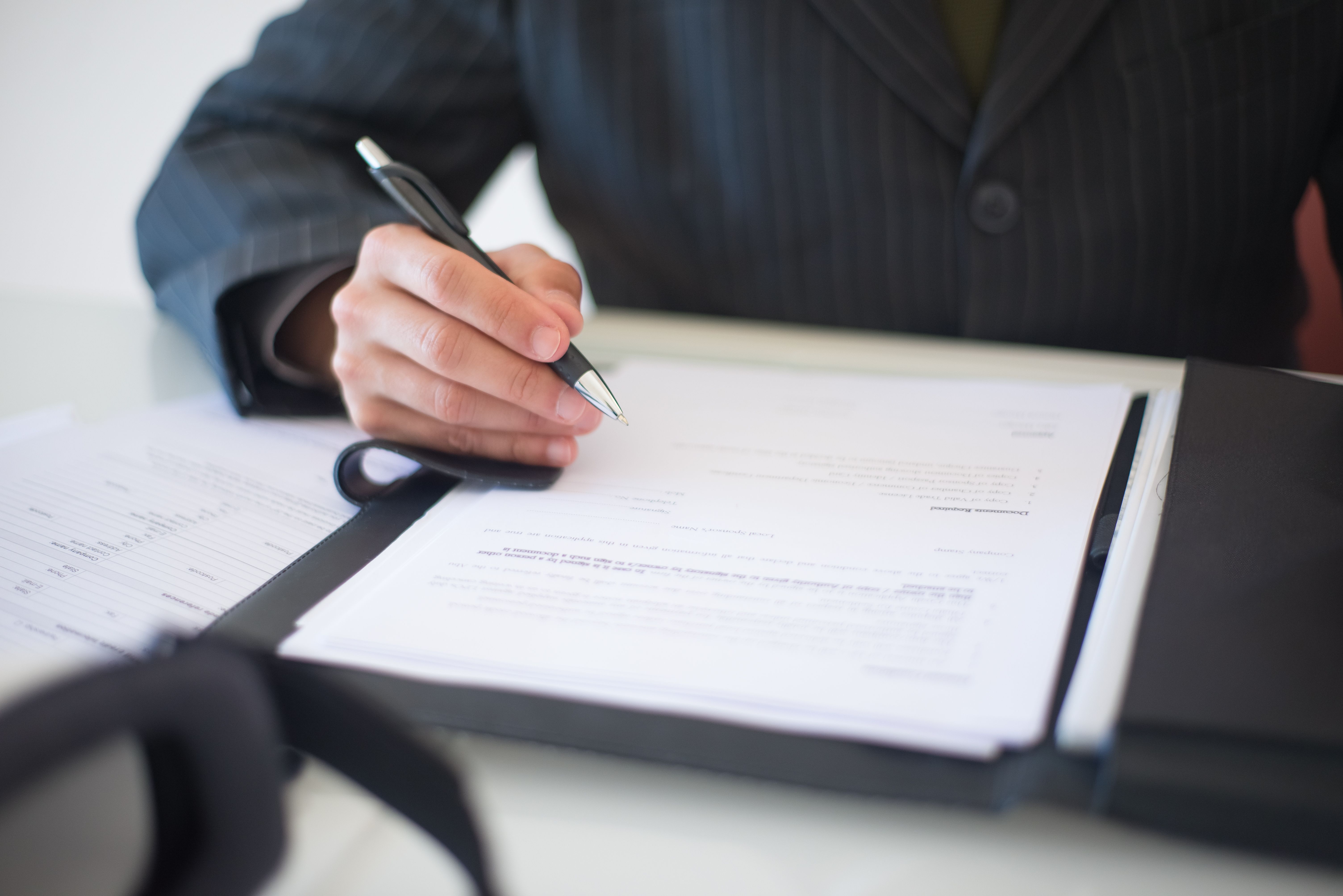 Executive signing health and safety compliance paperwork.