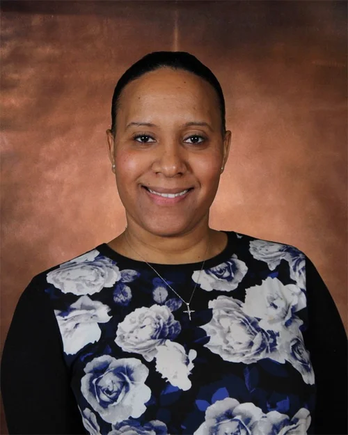 Ms. Esposito smiling in a floral top for staff directory