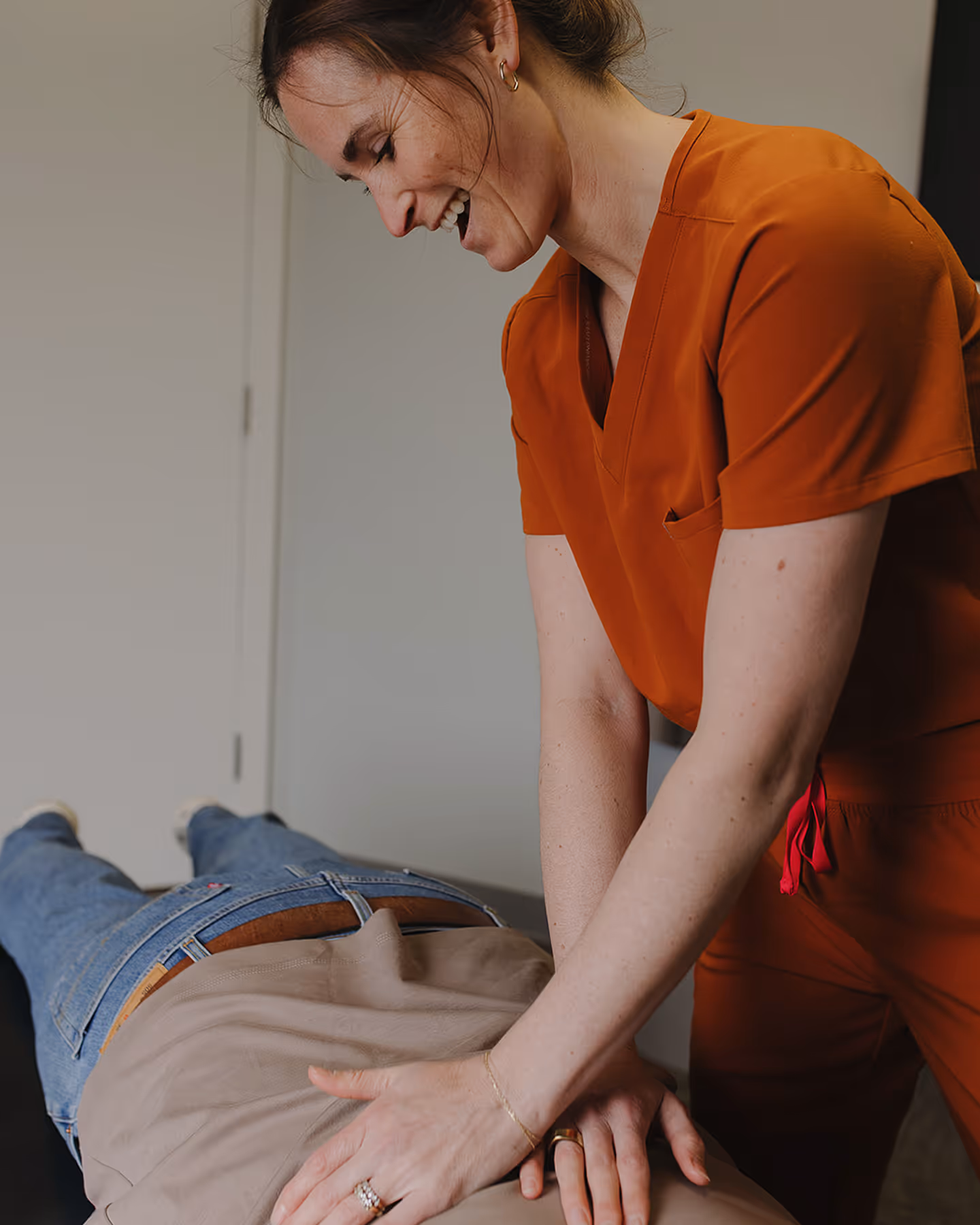 A woman getting a back massage from a massager.