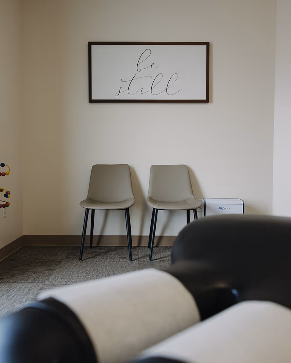 A couple of chairs sitting next to each other in a room.