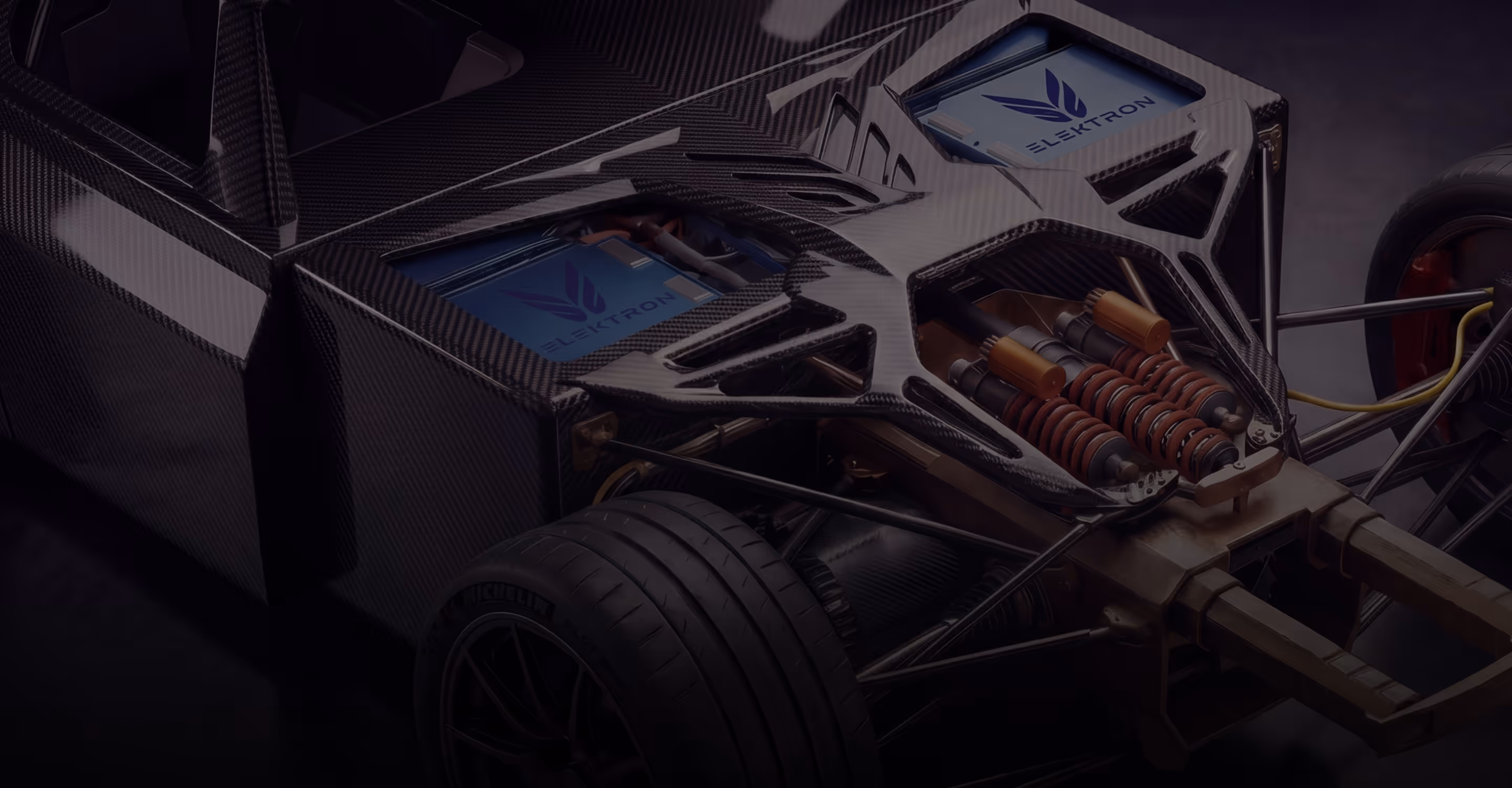 Close-up of a high-performance car engine with carbon fiber and metal components.