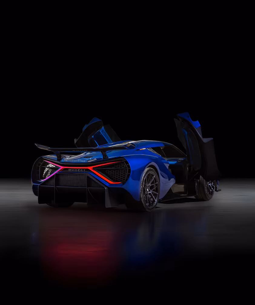 Rear and side view of a sleek blue sports car with illuminated red taillights in a dark setting.