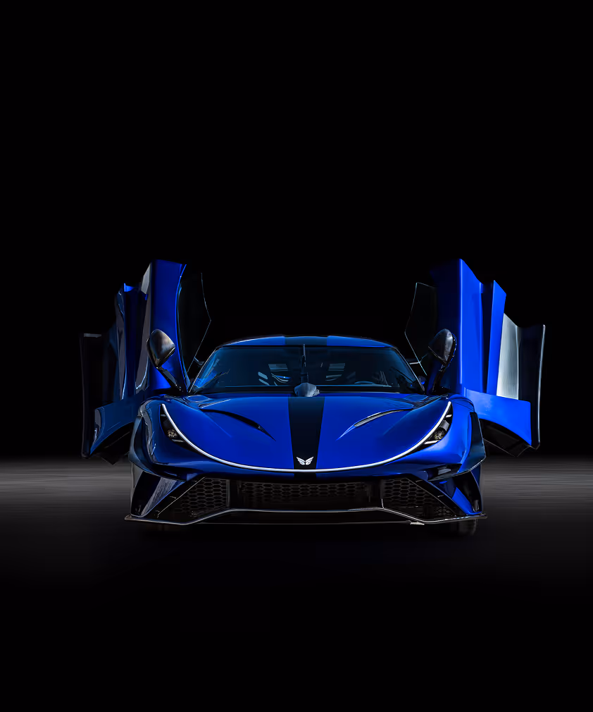 Front view of a sleek blue sports car with aerodynamic design and reflections on the hood.