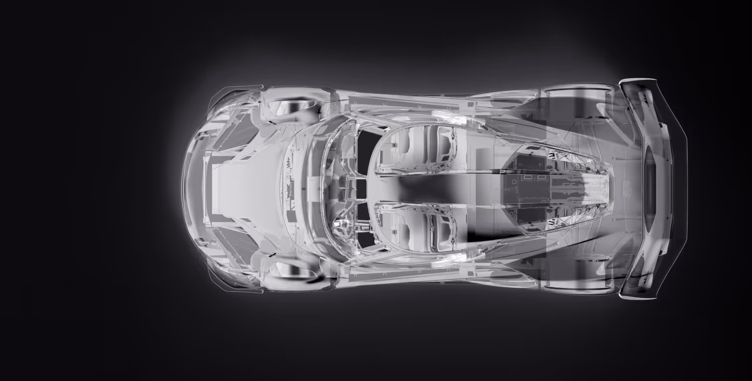 Black futuristic open-frame car chassis with visible carbon fiber texture and four tires on a reflective surface.