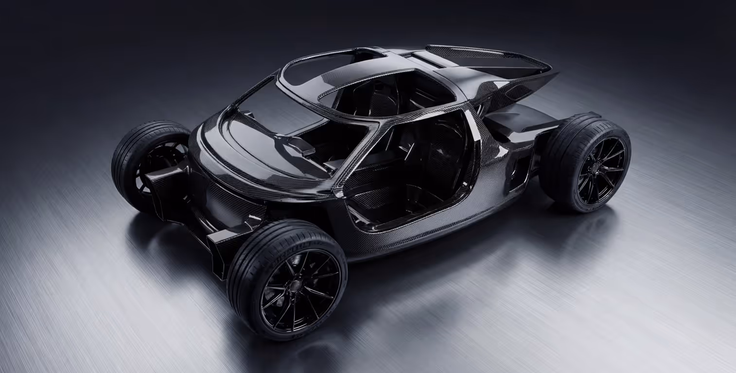Sleek black carbon fiber car chassis with four wheels on a metallic surface.