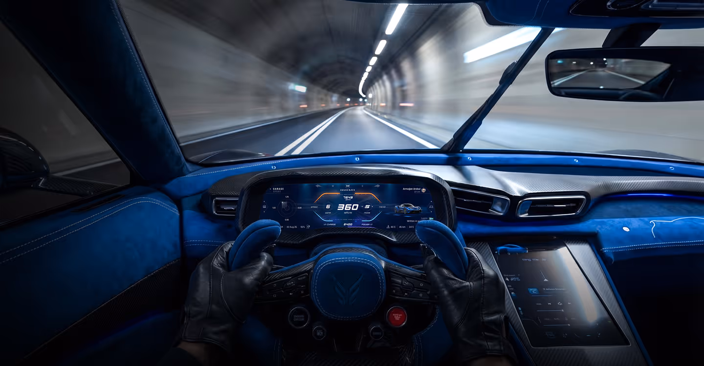 Driver wearing black gloves holding a blue racing-style steering wheel inside a blue luxury car driving through a tunnel.