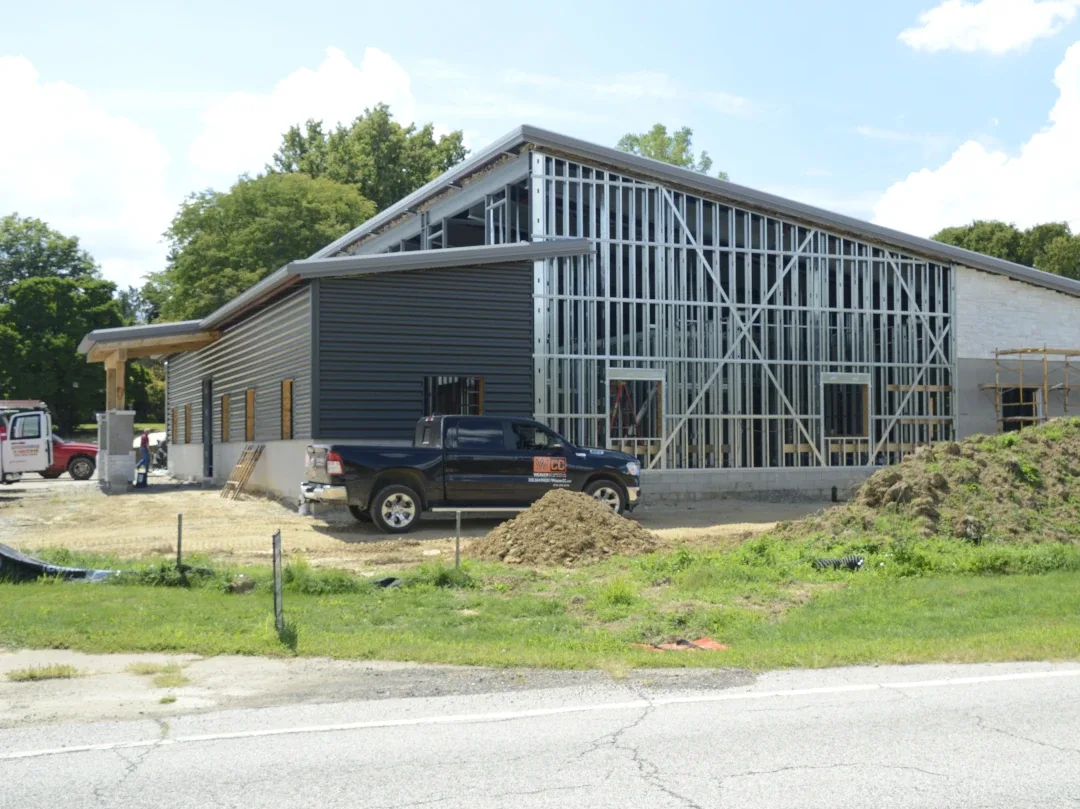 new build metal frame truck next to building