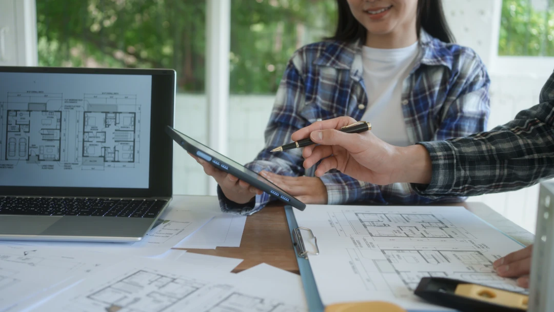 blueprints and schematics on laptop and papers