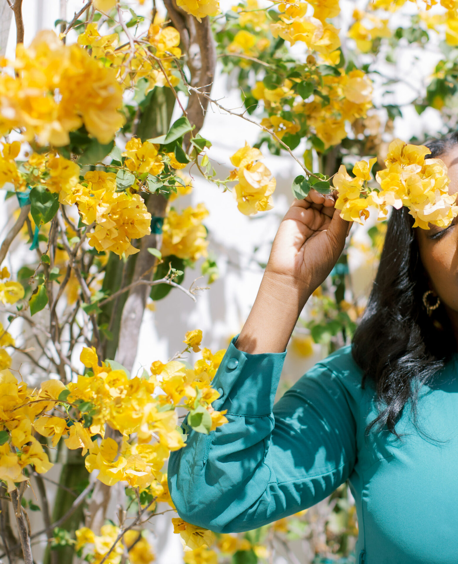 woman standing next to flowers