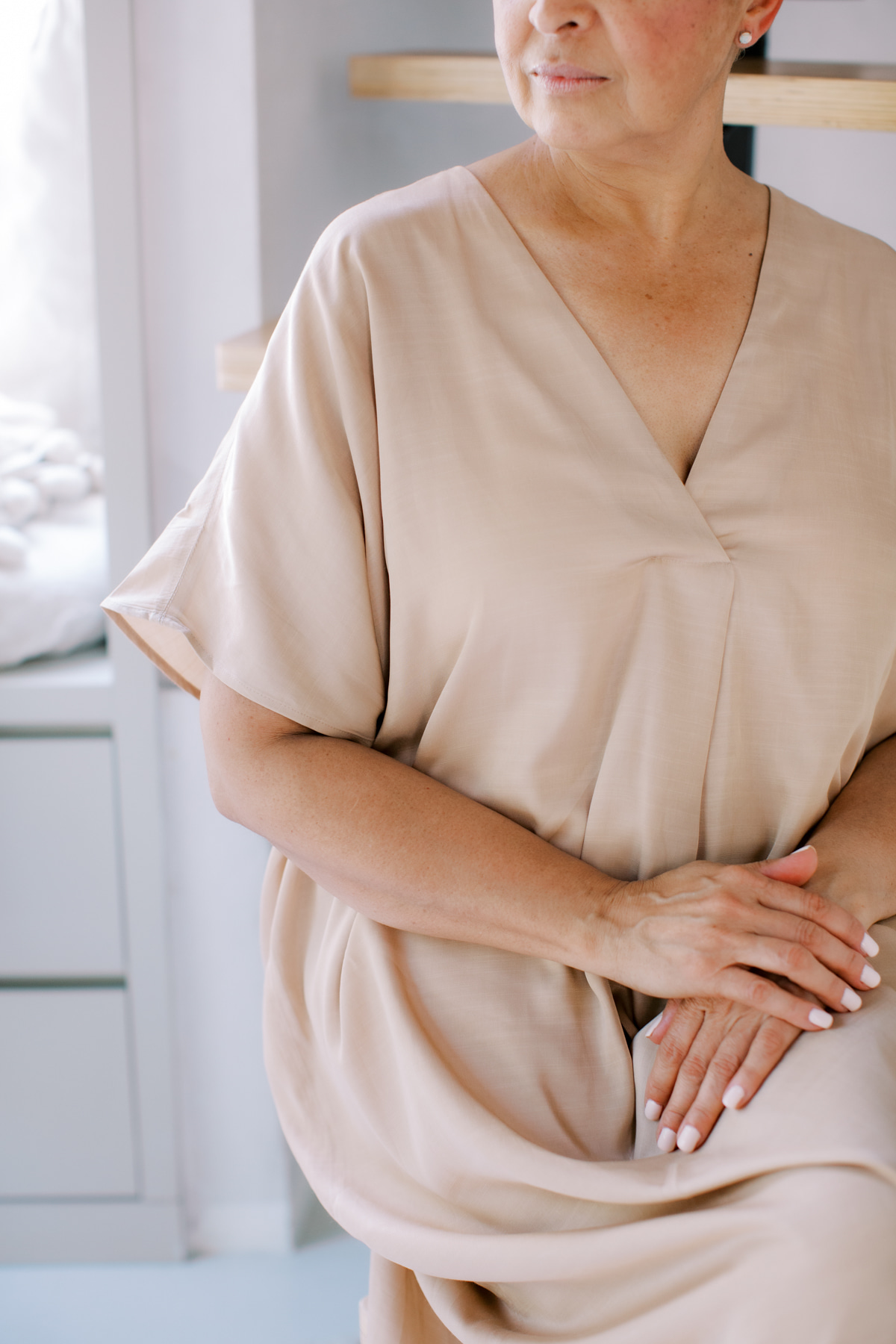 woman seating elegantly and looking at something off screen