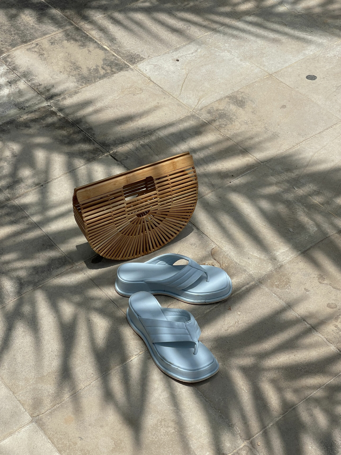 shoes and a purse laid out in an elegant way on the floor