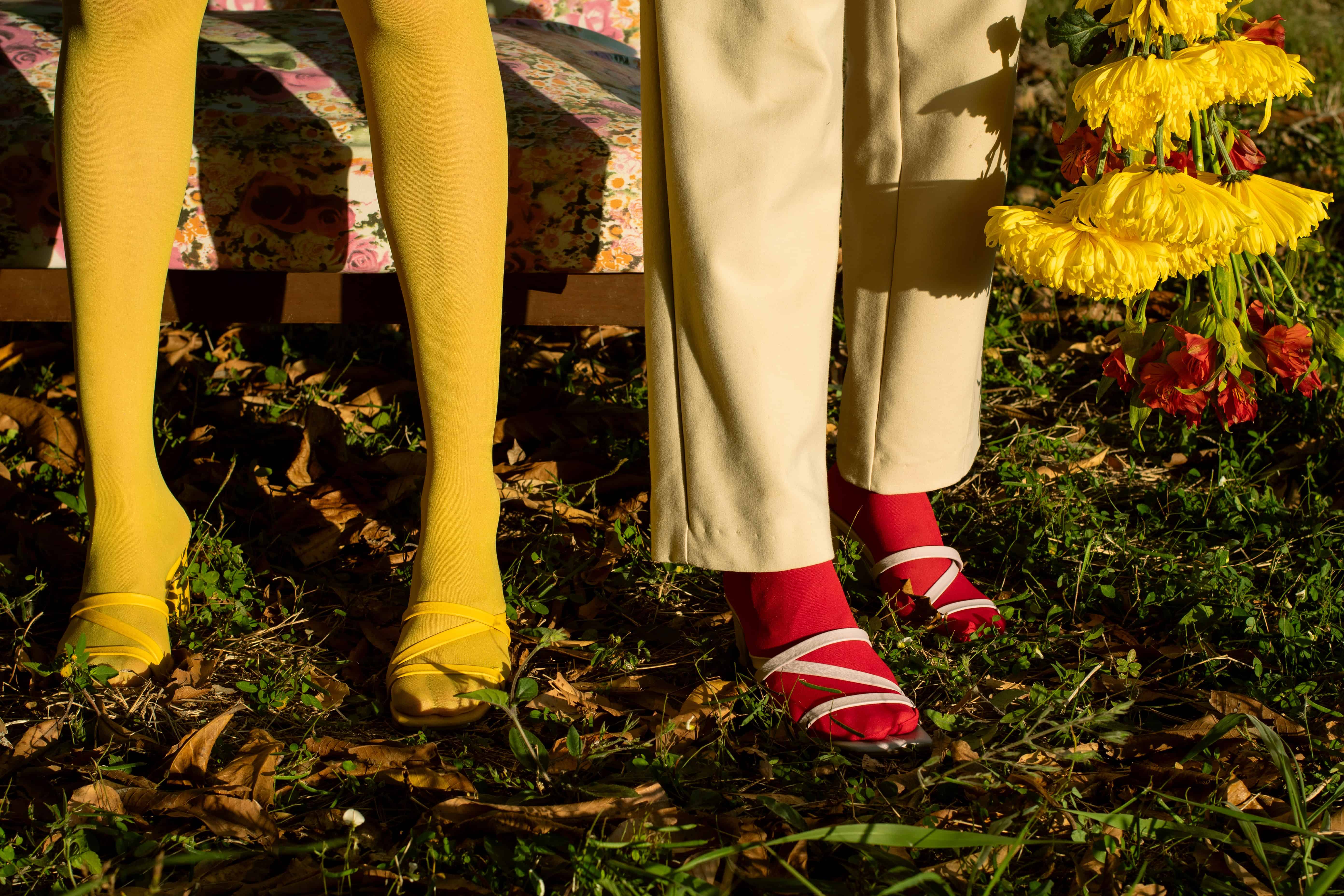 2 woman standing at what seems like a field wearing retro looking outfits