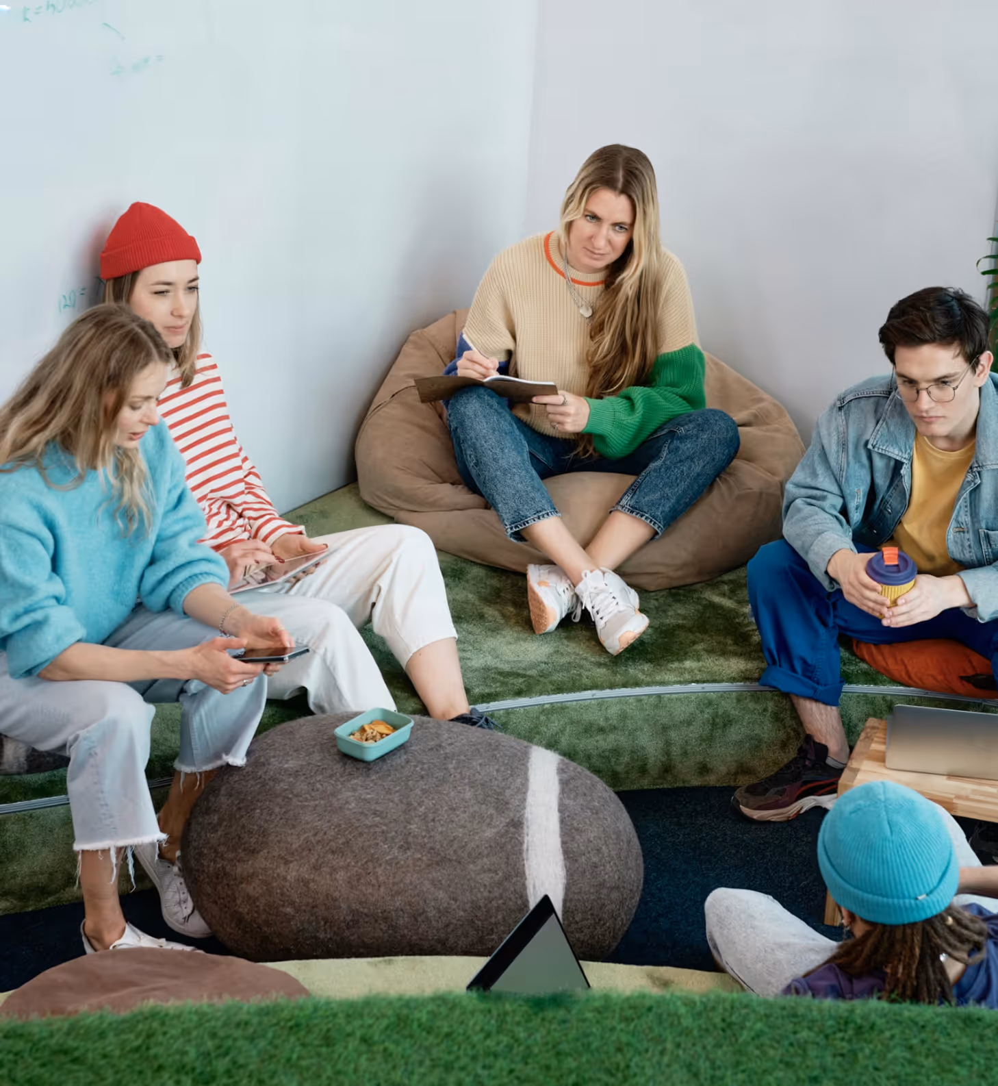 Flowpay team collaborating in a casual fintech strategy meeting, discussing product ideas and payment solutions together.