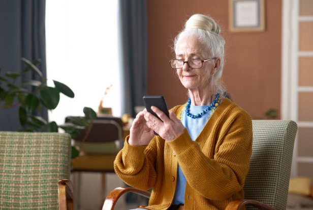 Senior woman typing a message on smartphone