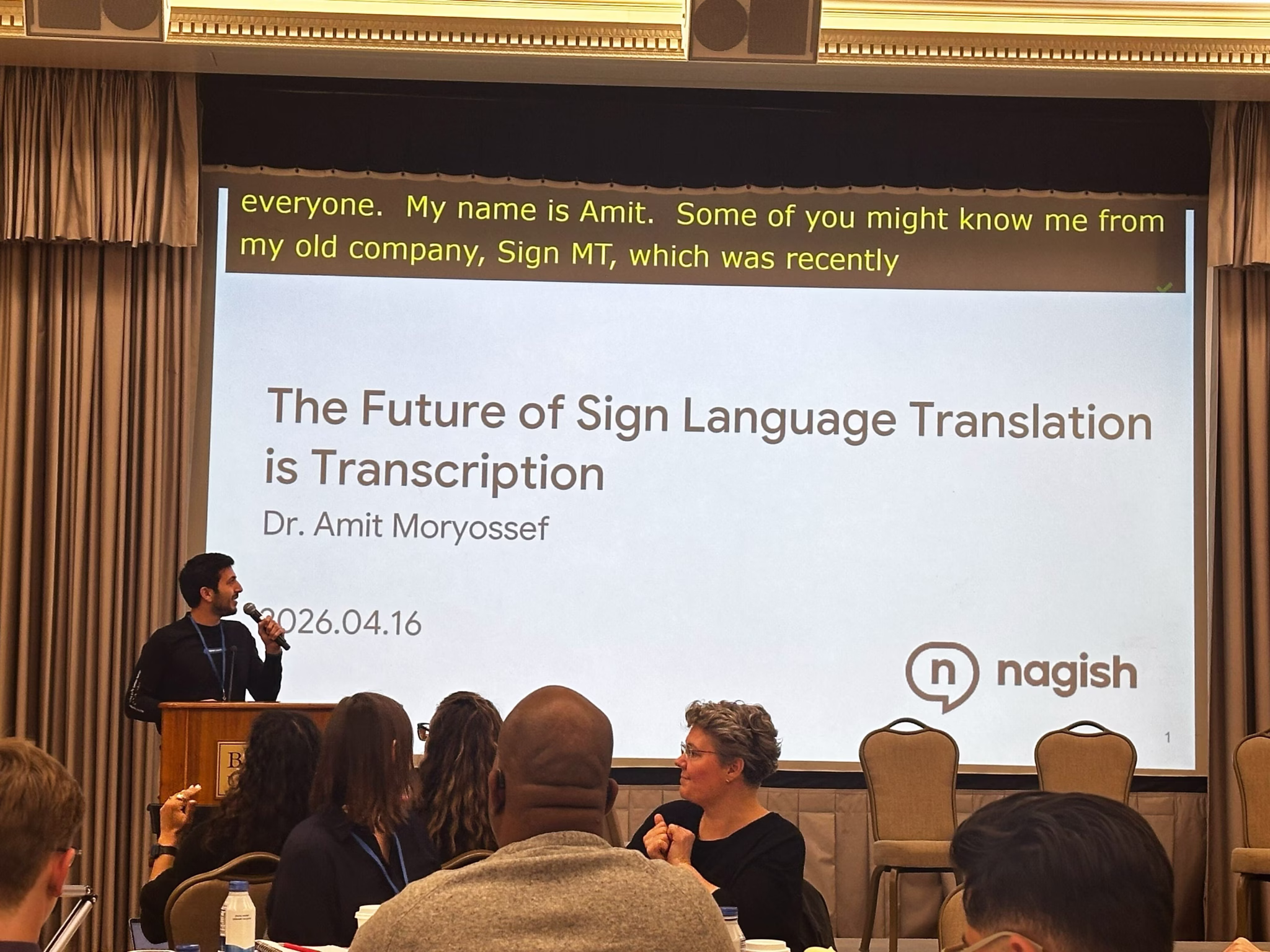 (Dr. Amit Moryossef giving a presentation at SlxAI 2026 in Boston University)