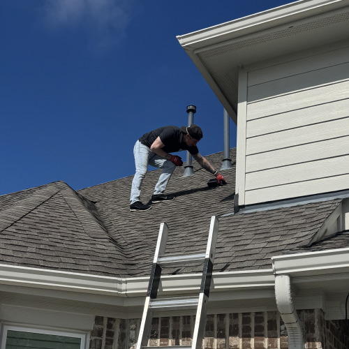 Hands repairing damaged roof shingles after hail storm