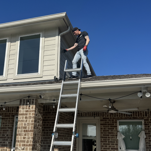 Roofing contractor walking on roof to inspect hail damage