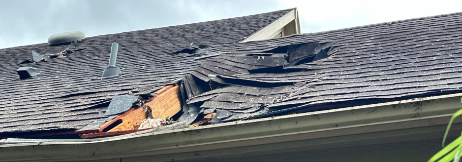 Close-up texture of roof shingles damaged by hail impact