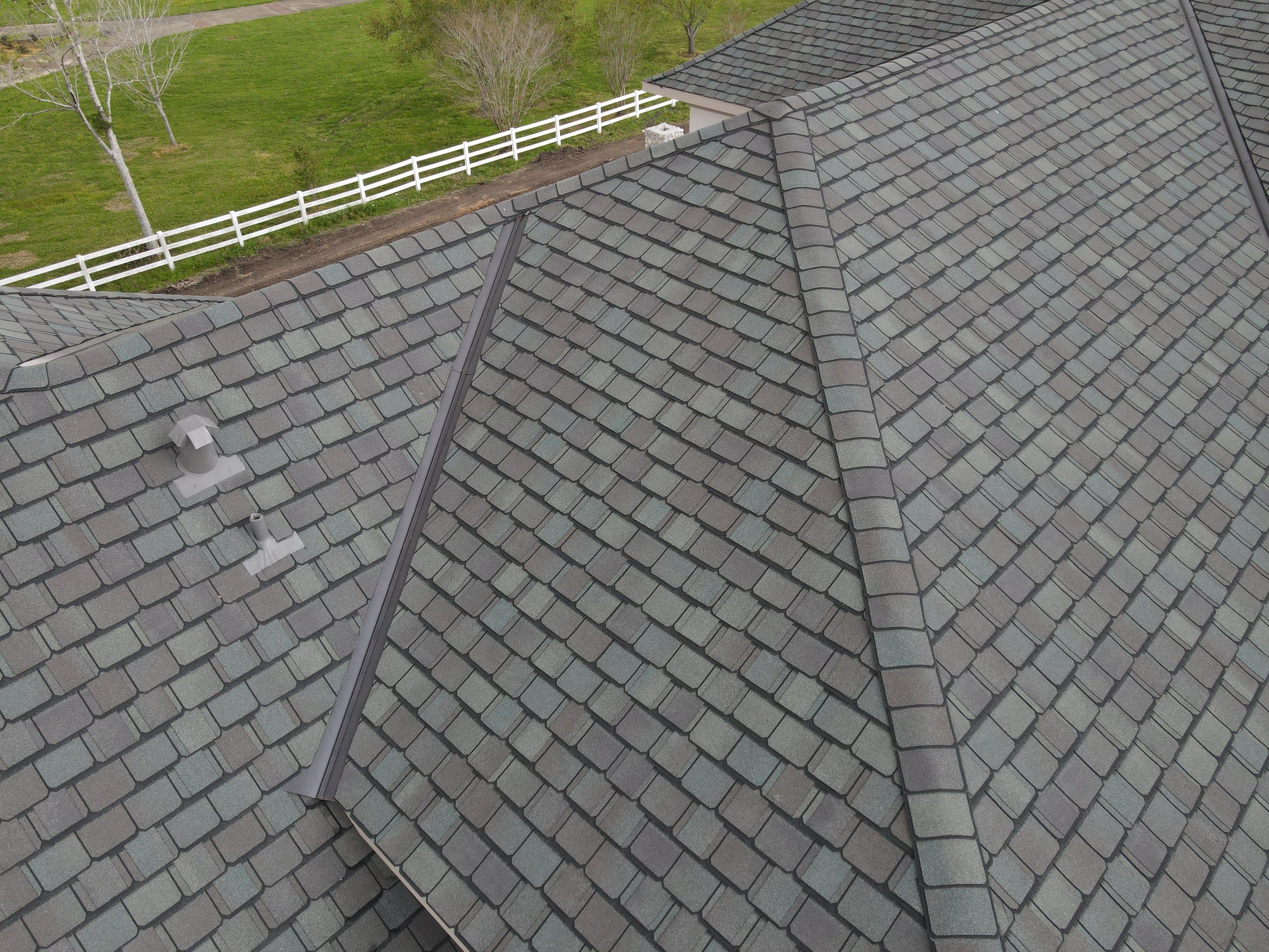 Hail-covered roof in Houston showing severe storm damage on shingles
