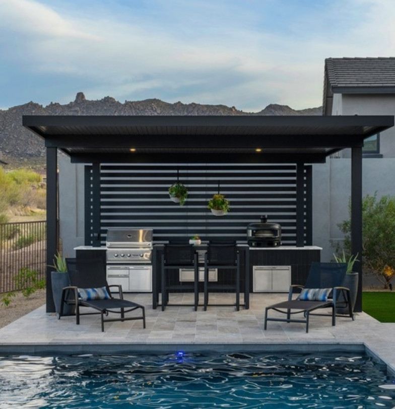 Backyard pool with black steel pergola, outdoor kitchen and travertine paver patio by Kevens Landscape