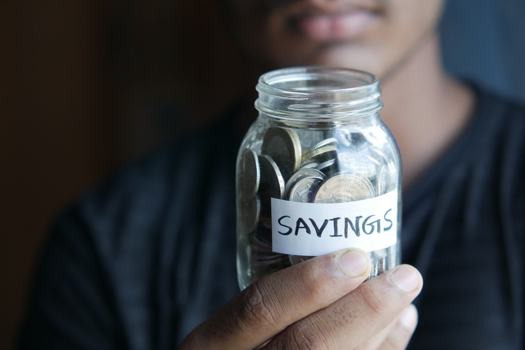 Person holding jar labeled 