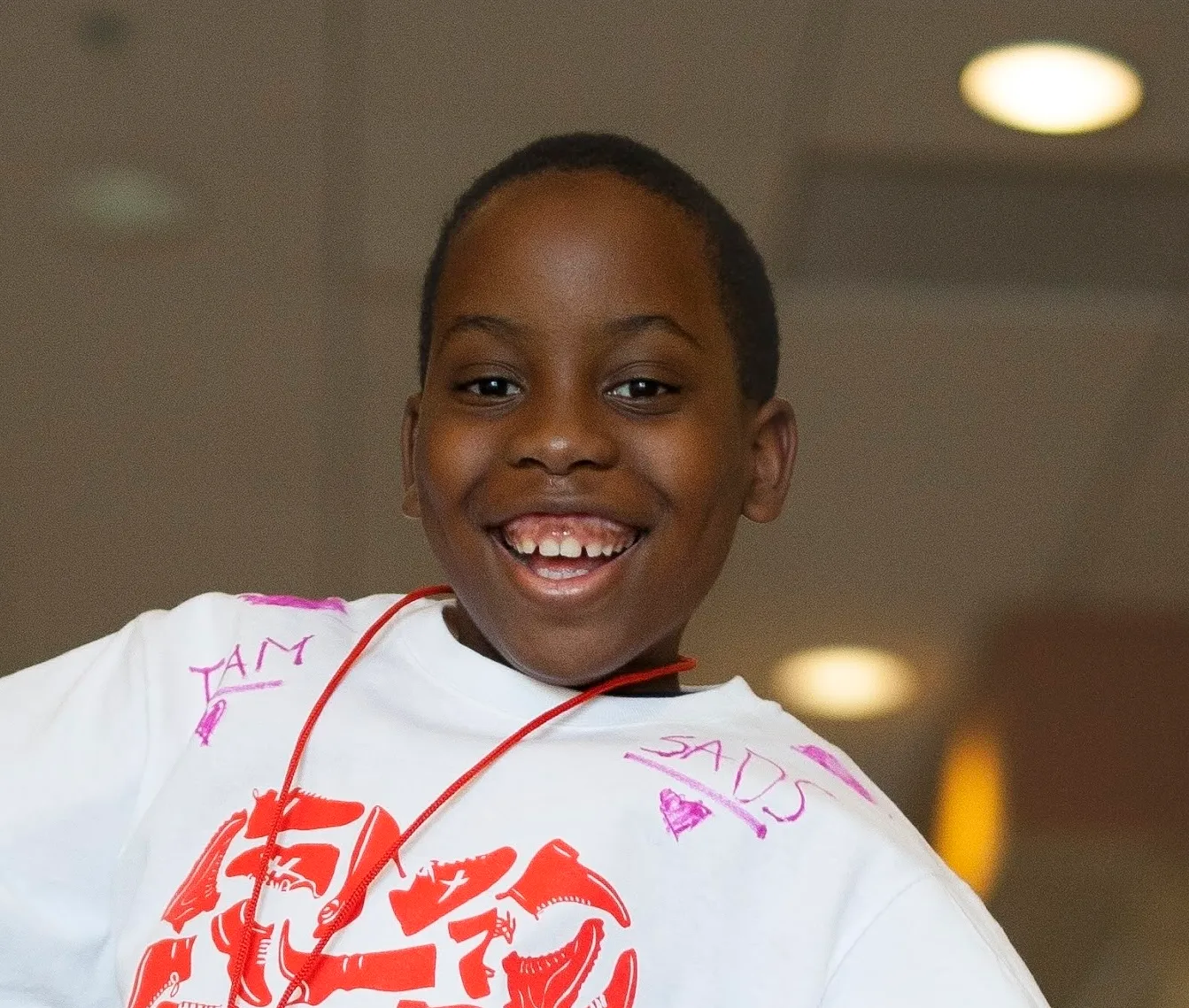 Smiling boy wearing a SADS Foundation shirt