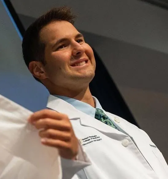 Alex posing with medical professionals