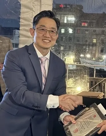 Man in a suit shaking hands at an event