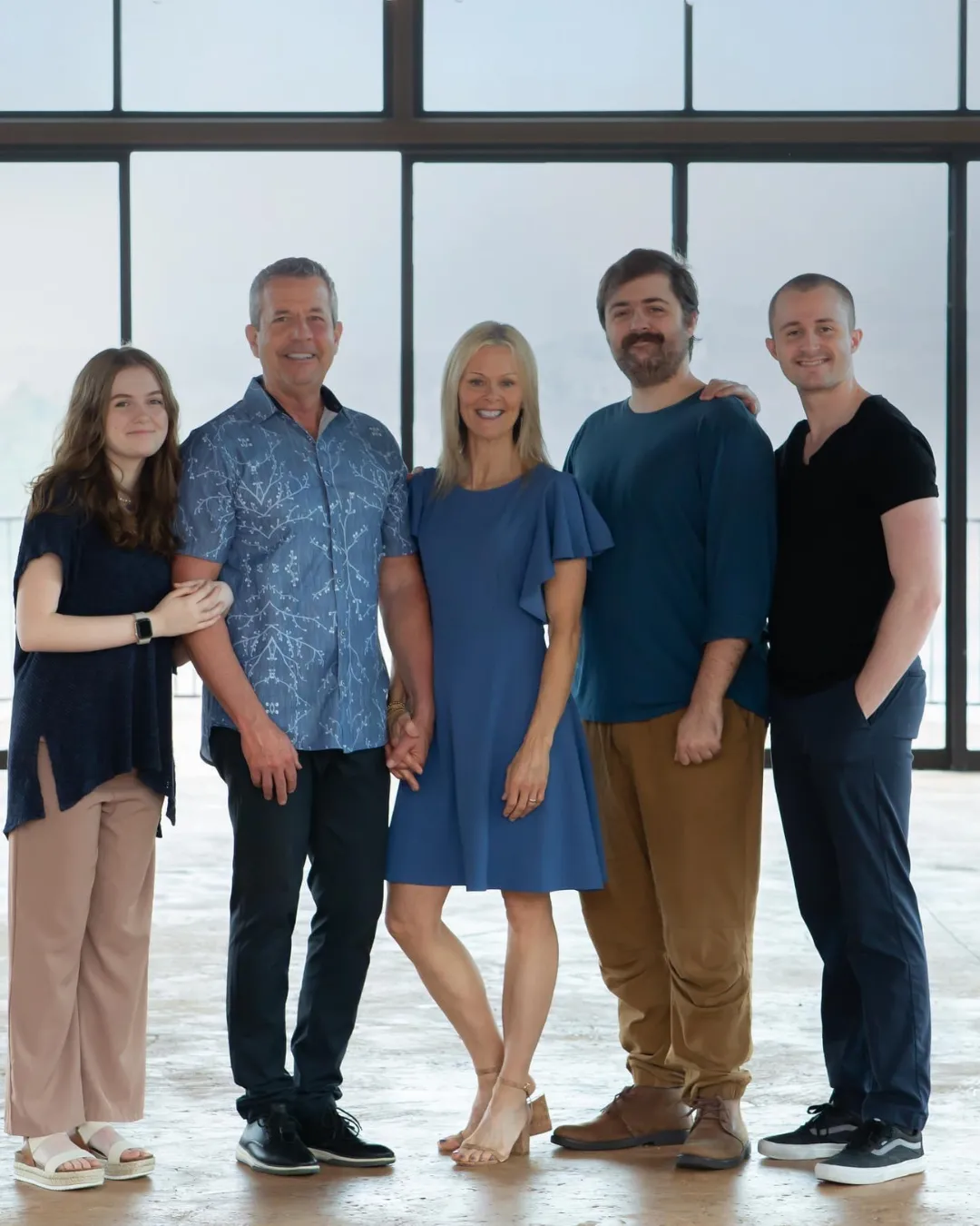 Family of five posing together indoors