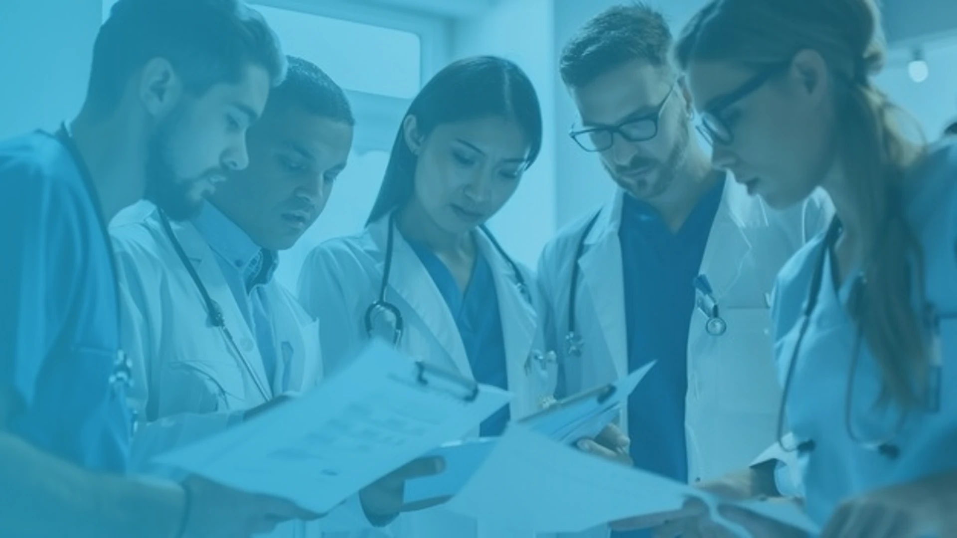 Healthcare students reviewing medical documents together during a training session.